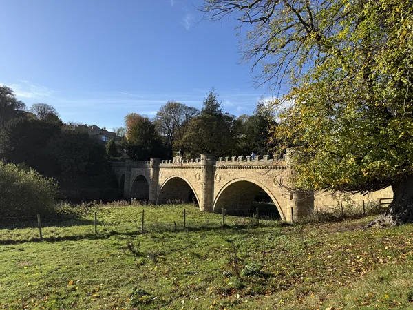 Stone arched bridge in autumn countryside